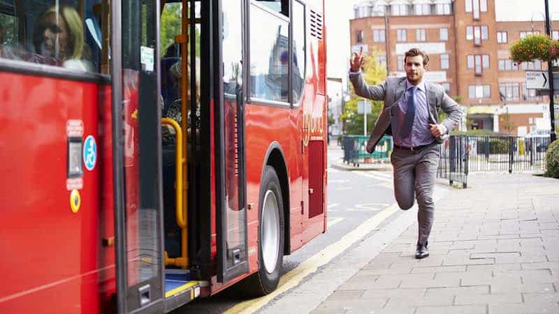 Man running to catch a bus