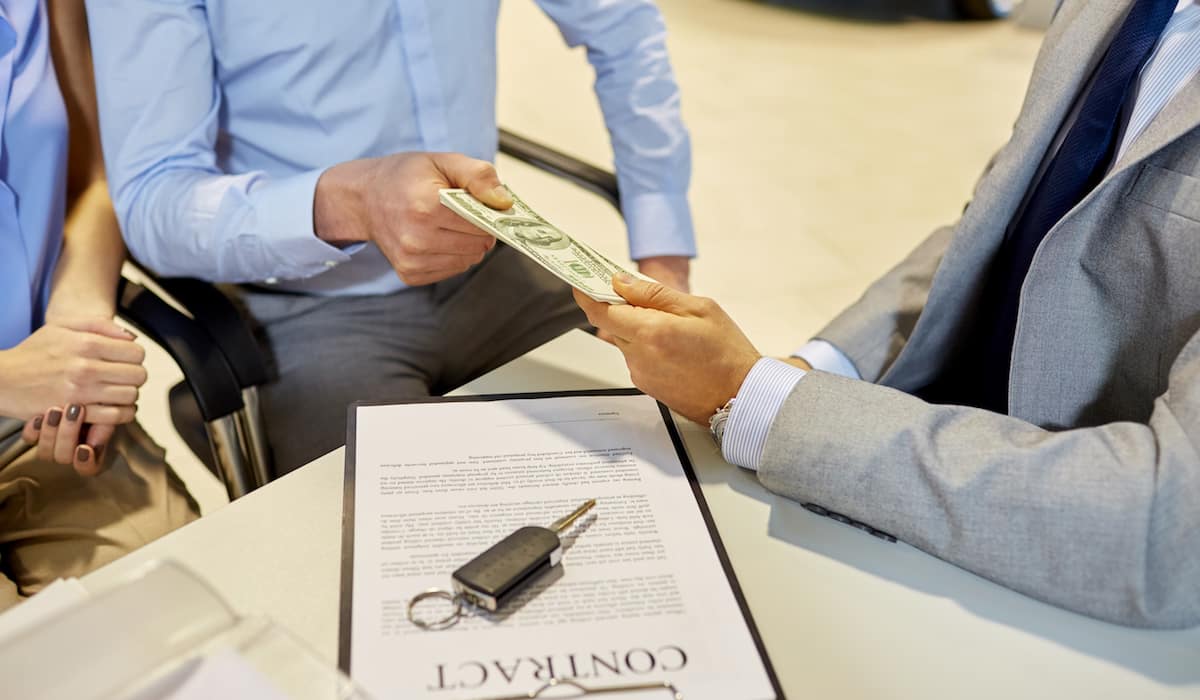 Giving a car dealer a cash deposit on a car